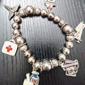 Silver toned beaded charm bracelet nurses.